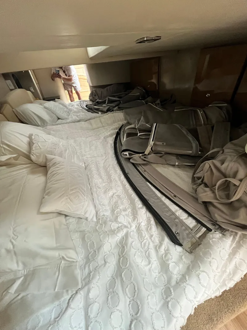 Slide: The Image of Interior cabin of 2013 Formula 400 SS FX8 with white bedding and stored equipment. - 15