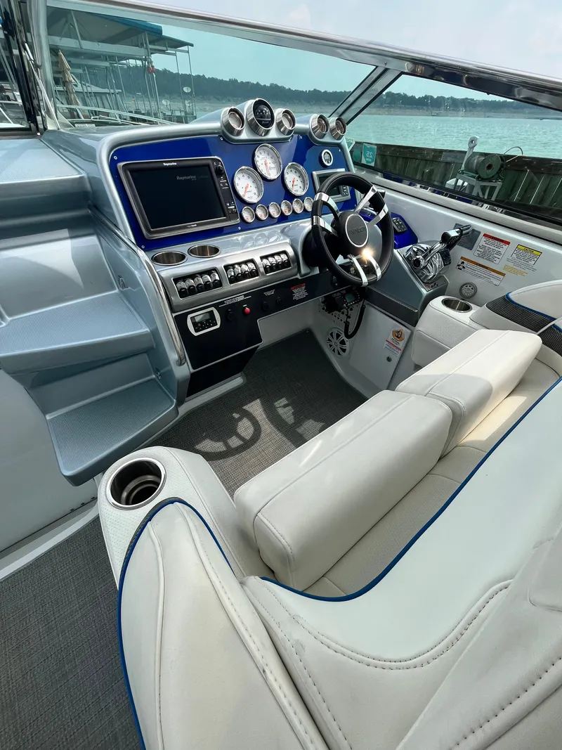 Slide: The Image of Interior of a 2013 Formula 400 SS FX8 boat, featuring a sleek control panel and plush seating. - 28