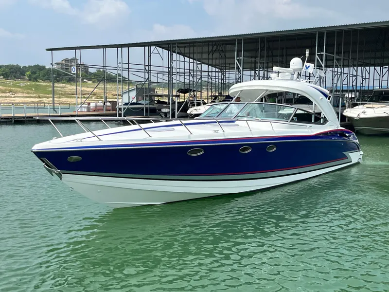 Slide: The Image of 2013 Formula 400 SS FX8 boat docked on calm water. - 3