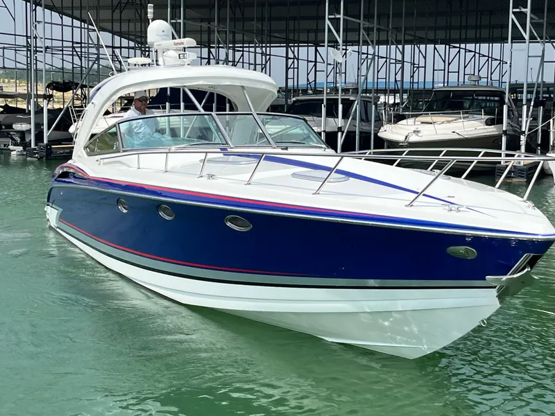 Slide: The Image of 2013 Formula 400 SS FX8 boat docked in marina, blue and white exterior. - 7