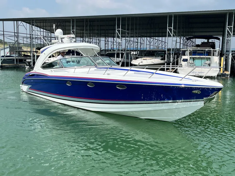 Slide: The Image of 2013 Formula 400 SS FX8 boat docked in marina, blue and white exterior. - 8