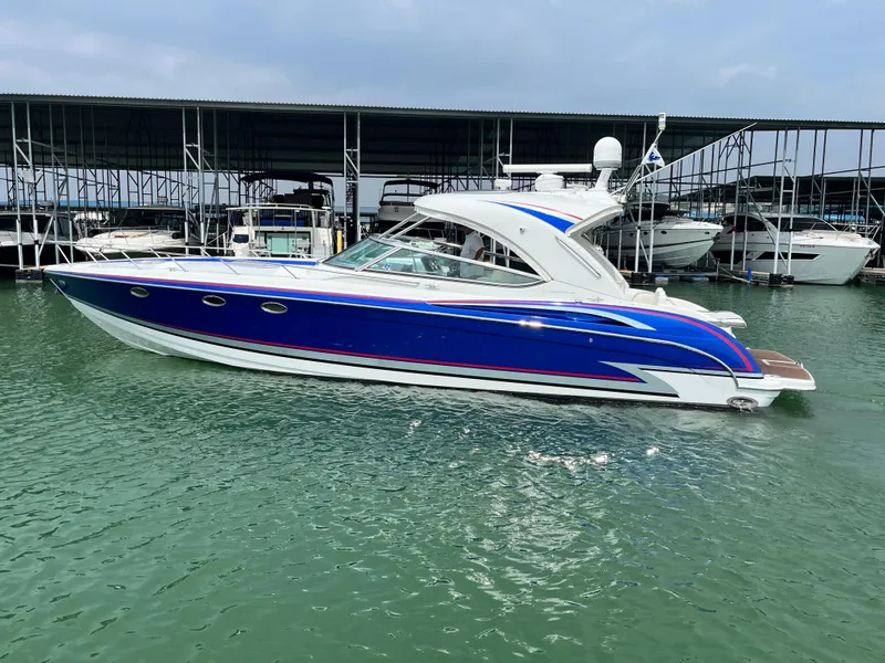 The Image of 2013 Formula 400 SS FX8 boat docked in marina, featuring sleek blue and white design. - 0