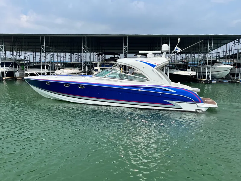 Slide: The Image of 2013 Formula 400 SS FX8 boat docked in marina, blue and white design. - 1