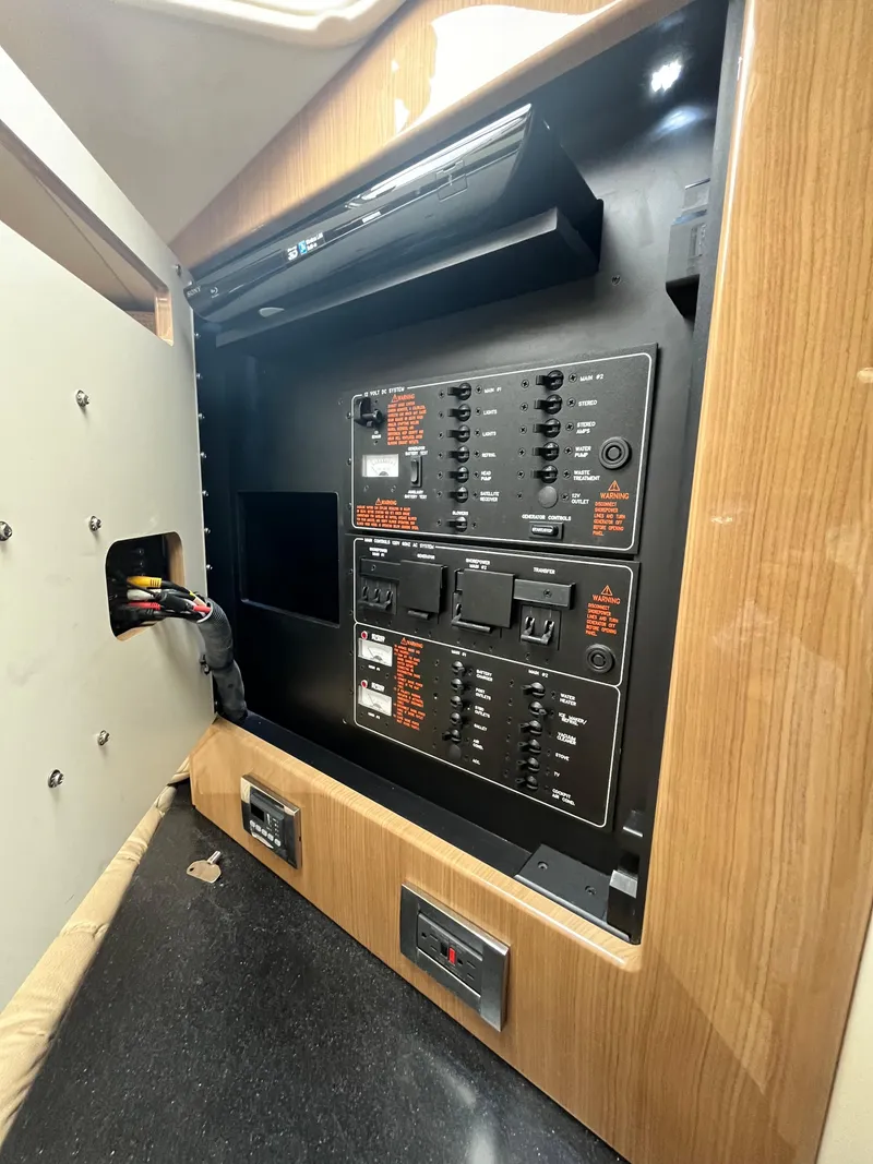 Slide: The Image of Control panel inside 2013 Formula 400 SS FX8 boat, featuring switches and wiring. - 12