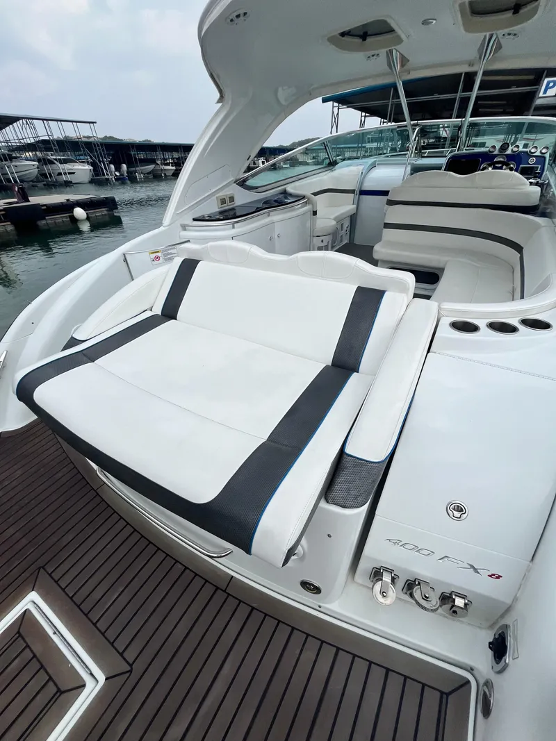 Slide: The Image of 2013 Formula 400 SS FX8 boat with sleek white seating and modern design at a marina. - 23