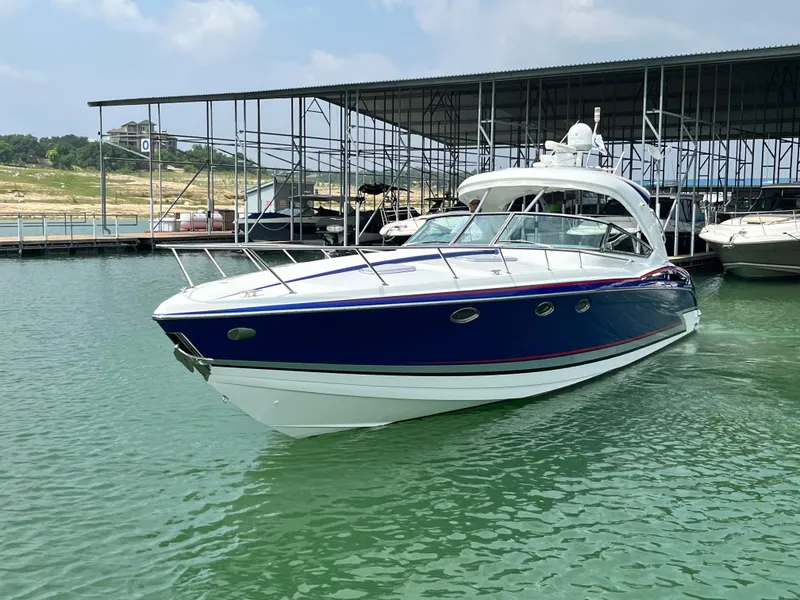 Slide: The Image of 2013 Formula 400 SS FX8 boat docked in a marina, clear water, sunny day. - 4