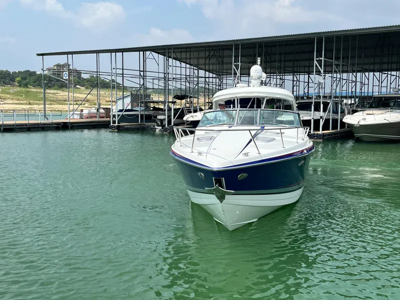 Slide: The Image of 2013 Formula 400 SS FX8 boat docked in marina, calm water, clear sky. - 5