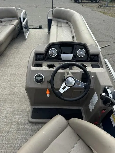 Slide: The Image of 2023 Ranger R 200C boat interior with steering wheel and dashboard controls. - 6