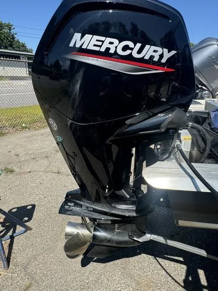 Slide: The Image of 2023 Ranger R 200C with Mercury outboard motor, parked outdoors. - 8