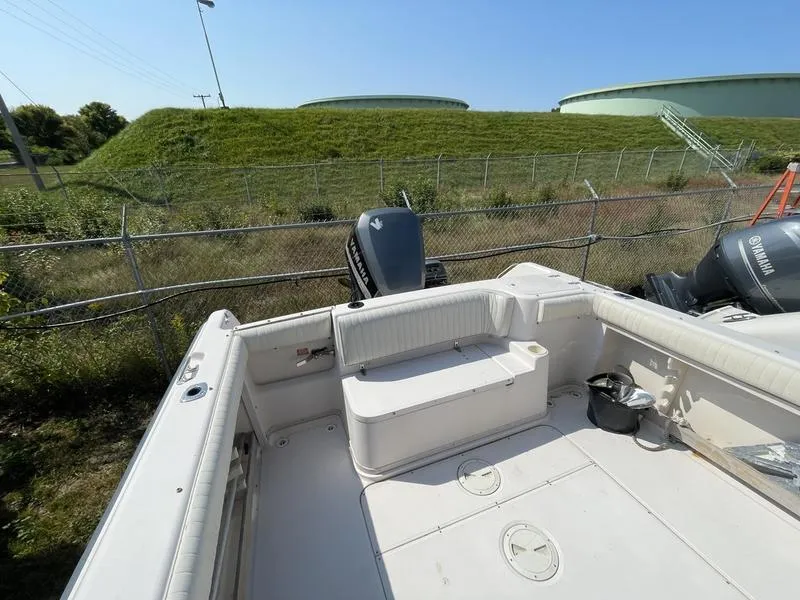 Slide: The Image of 1997 Grady-White 268 Islander boat interior with seating and outboard motor. - 12