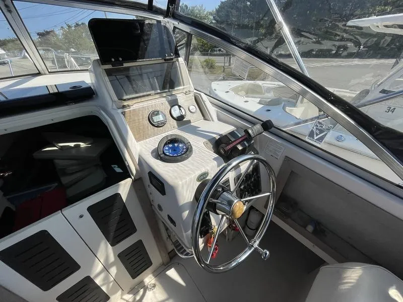 Slide: The Image of 1997 Grady-White 268 Islander boat cockpit with steering wheel and navigation instruments. - 3