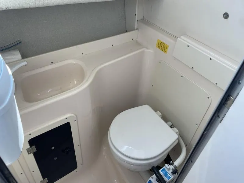 Slide: The Image of 1997 Grady-White 268 Islander boat bathroom interior with toilet and sink. - 7