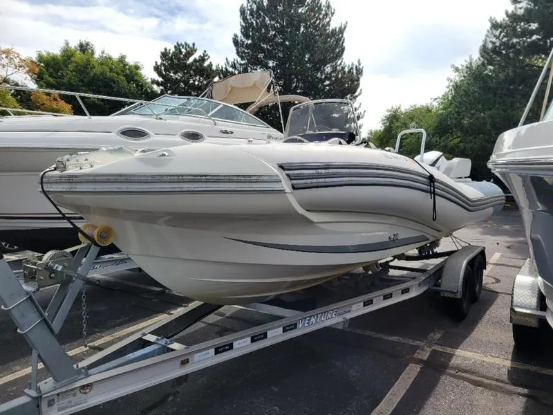 Slide: The Image of 2018 Zodiac NZO 22 boat on trailer, parked outdoors. - 11