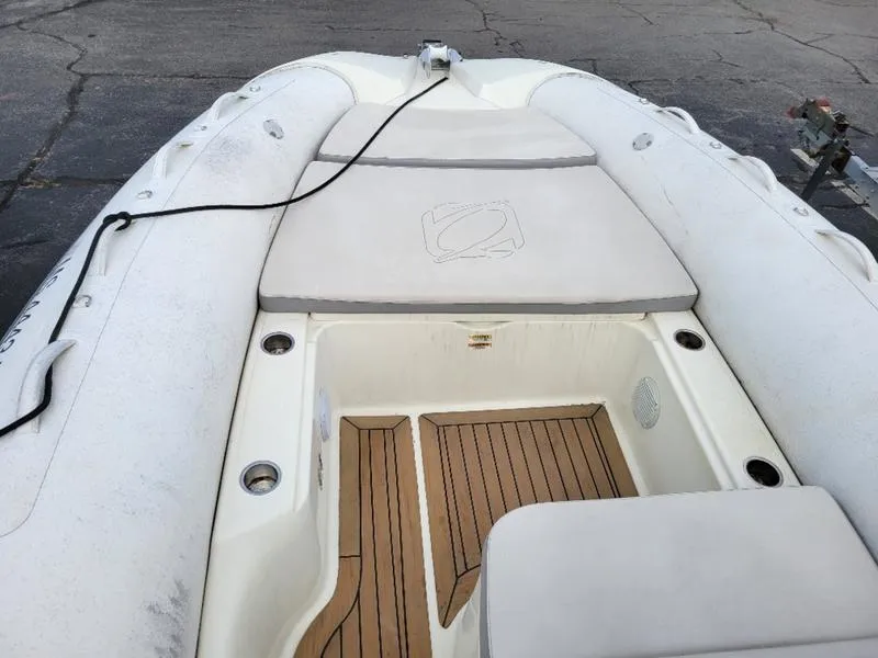 Slide: The Image of 2018 Zodiac NZO 22 inflatable boat with cushioned seating and wood-patterned flooring. - 12