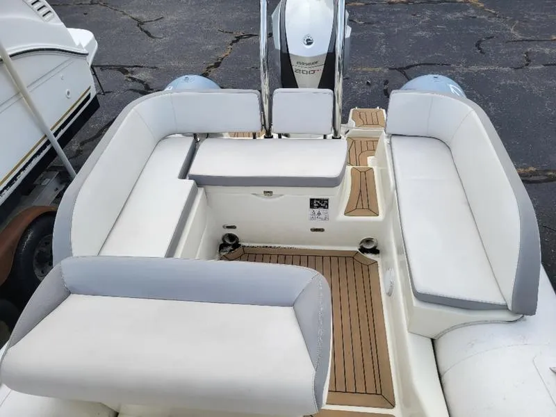 Slide: The Image of 2018 Zodiac NZO 22 boat interior with white cushioned seating and wooden flooring. - 13