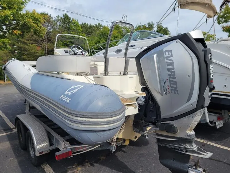Slide: The Image of 2018 Zodiac NZO 22 boat with Evinrude engine on trailer, parked outdoors. - 14