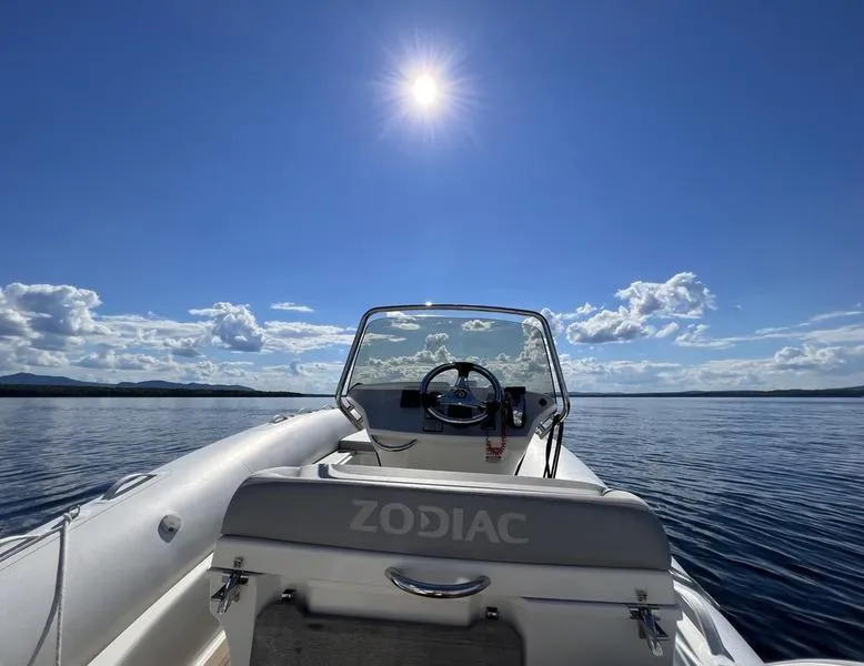 Slide: The Image of Zodiac NZO 22 boat on calm water under clear blue sky, 2018 model. - 17