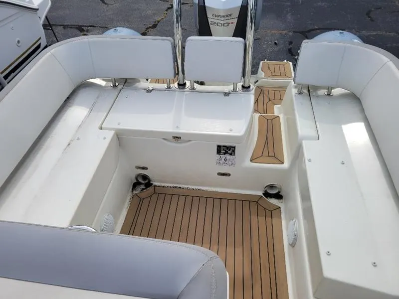 Slide: The Image of 2018 Zodiac NZO 22 boat interior with cushioned seating and teak flooring. - 2