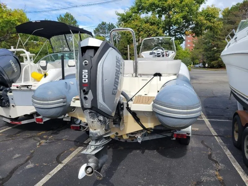 Slide: The Image of 2018 Zodiac NZO 22 boat with Evinrude engine in a parking lot. - 4