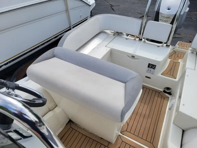 Slide: The Image of 2018 Zodiac NZO 22 boat interior with cushioned seating and wooden deck. - 6