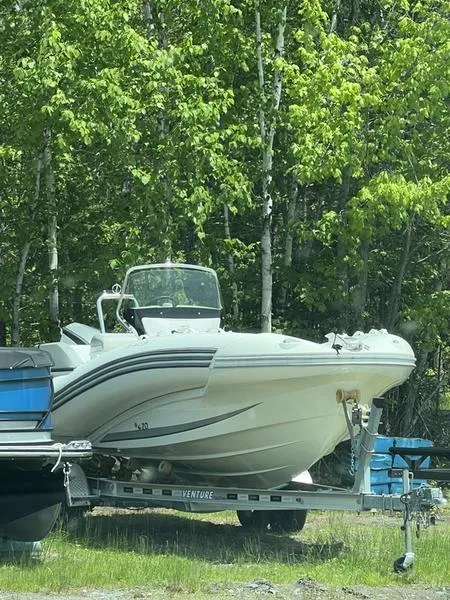 Slide: The Image of 2018 Zodiac NZO 22 boat on trailer, surrounded by lush green trees. - 9