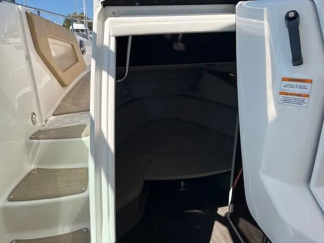 Slide: The Image of 2020 Sea Ray Sundancer 320 cabin entrance with steps and seating area. - 4