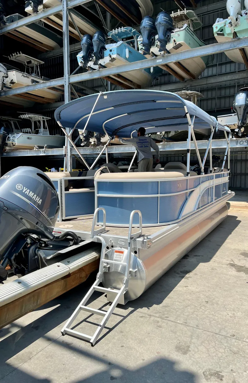 Slide: The Image of 2020 Bennington SX 23 SXSR pontoon boat with Yamaha motor in storage facility. - 2