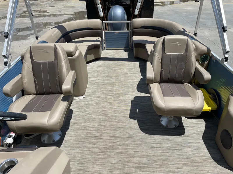 Slide: The Image of 2020 Bennington SX 23 SXSR pontoon boat interior with beige seating and spacious layout. - 22