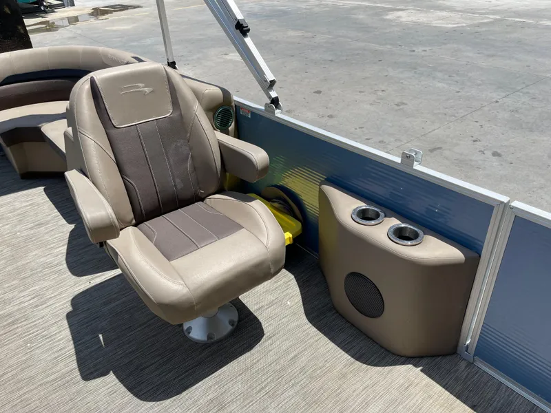 Slide: The Image of 2020 Bennington SX 23 SXSR boat interior with captain's chair and cup holders. - 23