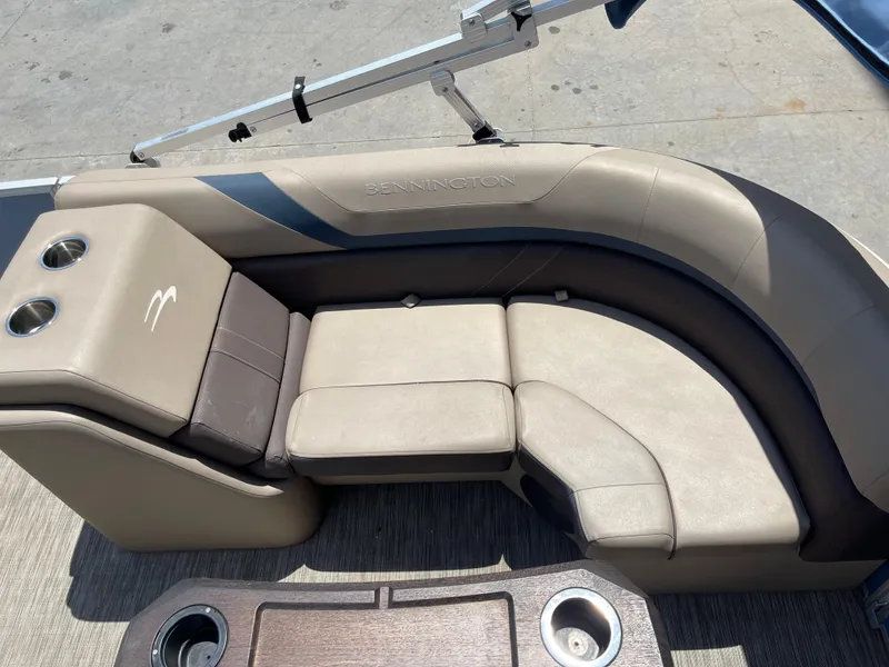 Slide: The Image of 2020 Bennington SX 23 SXSR boat seating with cup holders and beige upholstery. - 32