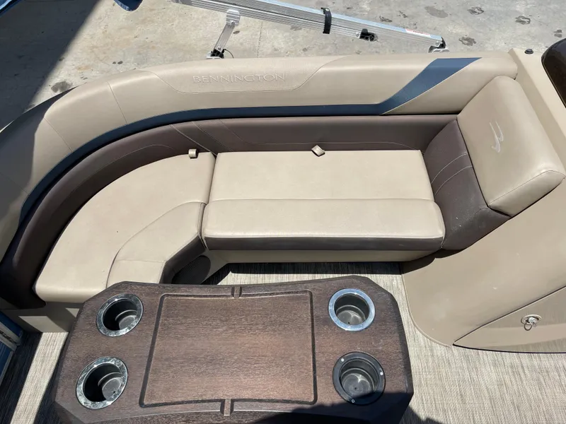Slide: The Image of 2020 Bennington SX 23 SXSR boat interior with beige seating and wooden table. - 35