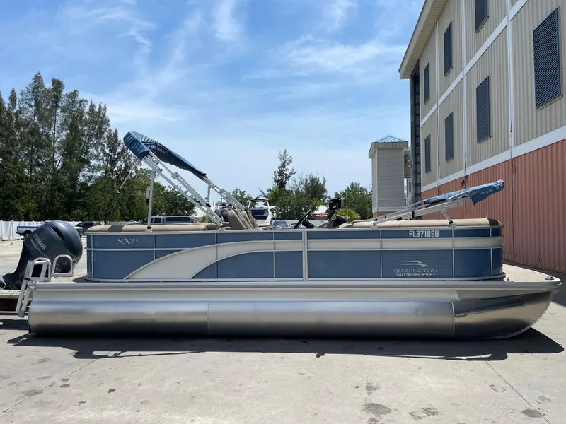 Slide: The Image of 2020 Bennington SX 23 SXSR pontoon boat parked outdoors. - 6