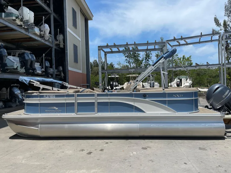 Slide: The Image of 2020 Bennington SX 23 SXSR pontoon boat in storage yard. - 7