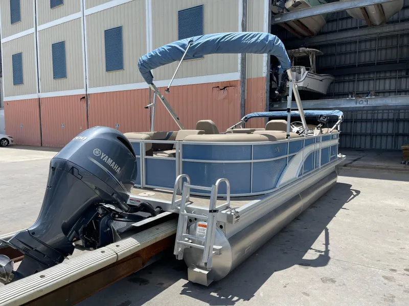 Slide: The Image of 2020 Bennington SX 23 SXSR pontoon boat with Yamaha outboard motor in storage facility. - 9