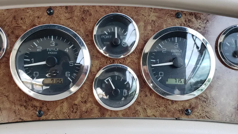 Slide: The Image of Dashboard of 2000 Sea Ray 290 Sundancer with RPM and fuel gauges. - 14