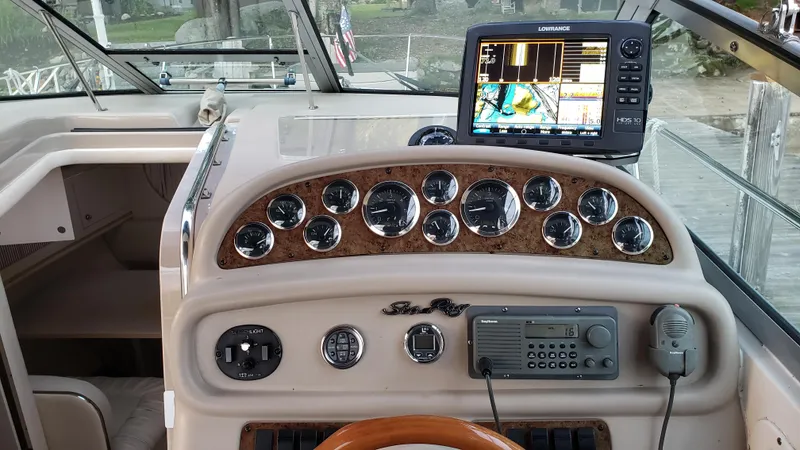 Slide: The Image of Dashboard of a 2000 Sea Ray 290 Sundancer with navigation equipment and controls. - 15