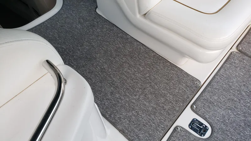 Slide: The Image of Interior of 2000 Sea Ray 290 Sundancer with gray carpet and white seating. - 16