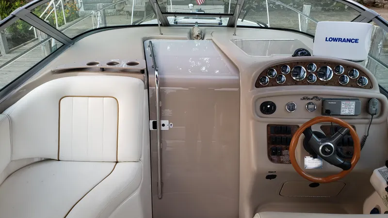 Slide: The Image of 2000 Sea Ray 290 Sundancer helm with steering wheel, gauges, and Lowrance navigation system. - 5