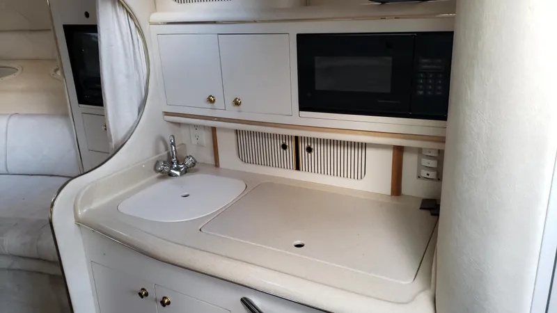 Slide: The Image of Interior view of 2000 Sea Ray 290 Sundancer kitchenette with sink and microwave. - 6