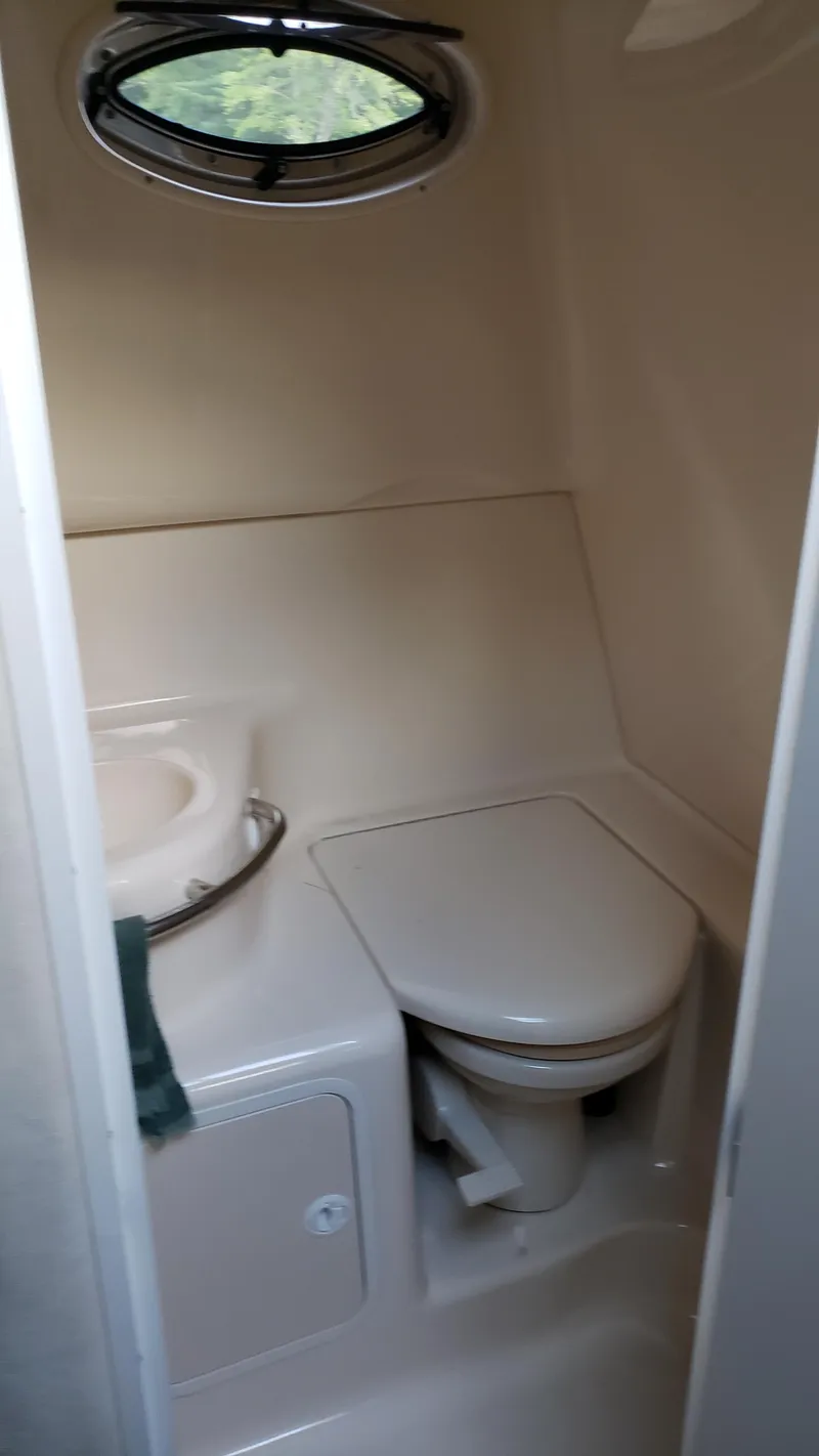 Slide: The Image of 2000 Sea Ray 290 Sundancer boat bathroom with toilet and sink. - 8