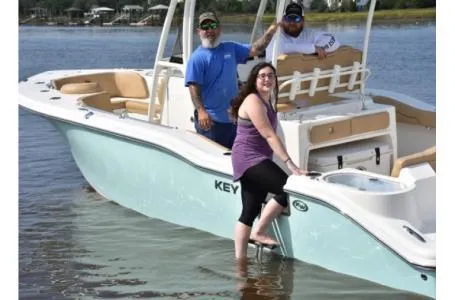 Slide: The Image of 2021 Key West 263FS boat with three people enjoying a day on the water. - 10