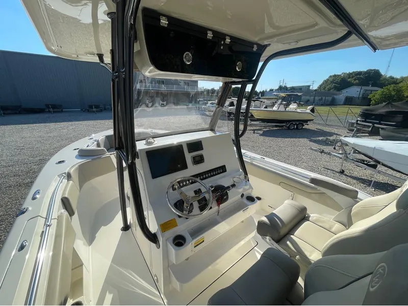 Slide: The Image of 2021 Key West 263FS boat interior with steering console and seating. - 11