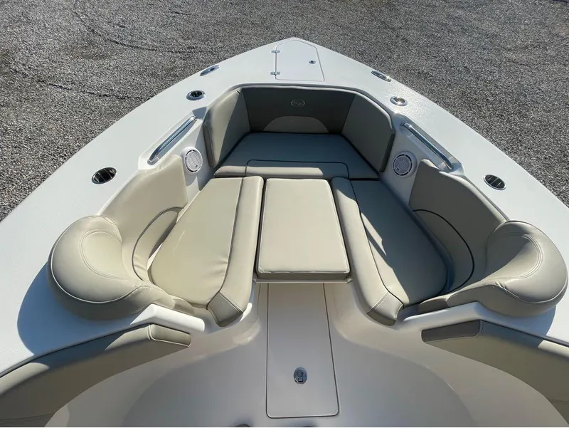 Slide: The Image of 2021 Key West 263FS boat interior with cushioned seating and cup holders. - 13