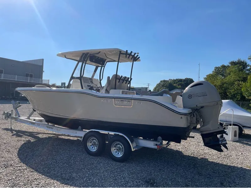 Slide: The Image of 2021 Key West 263FS boat on trailer, sunny day, gravel lot. - 14