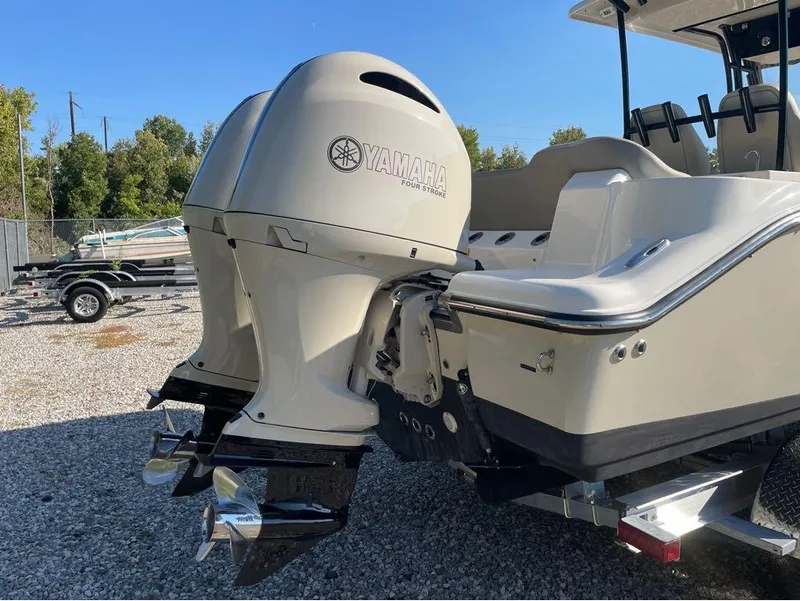 Slide: The Image of 2021 Key West 263FS boat with Yamaha outboard motor in a gravel lot. - 15