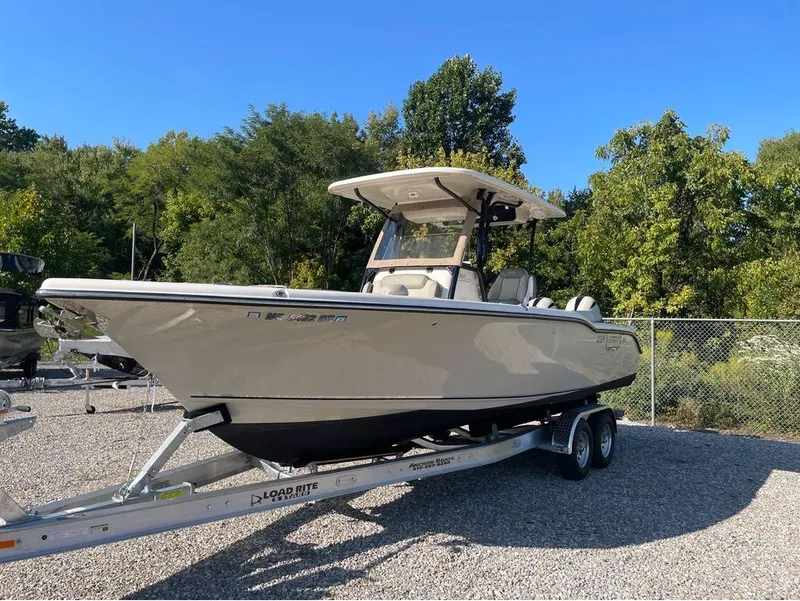 Slide: The Image of 2021 Key West 263FS boat on trailer, parked outdoors, sunny day. - 18
