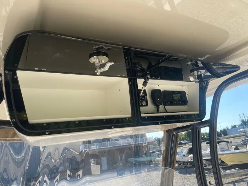 Slide: The Image of 2021 Key West 263FS boat console storage with radio equipment. - 19