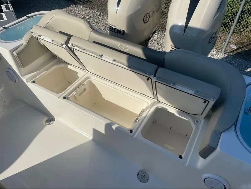 Slide: The Image of 2021 Key West 263FS boat with open storage compartments and Yamaha engines. - 22