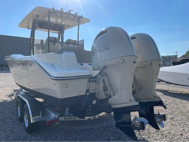 Slide: The Image of 2021 Key West 263FS boat with dual Yamaha engines on a trailer. - 23