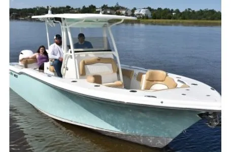 Slide: The Image of 2021 Key West 263FS boat on water with passengers, featuring sleek design and comfortable seating. - 27